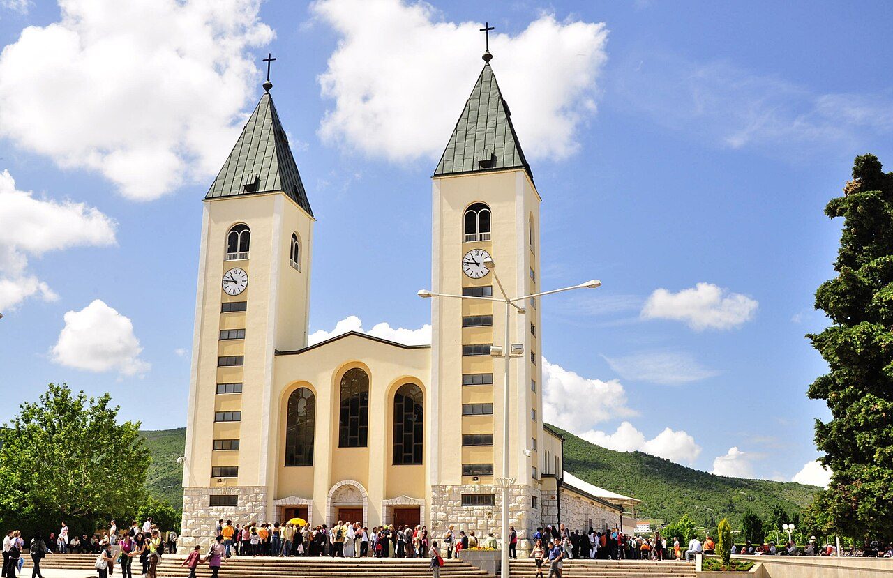 The twin towers of St. James Church in Međugorje under a blue sky