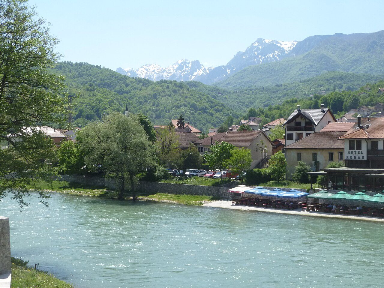 The wide green Neretva river at Konjic, with mountains behind