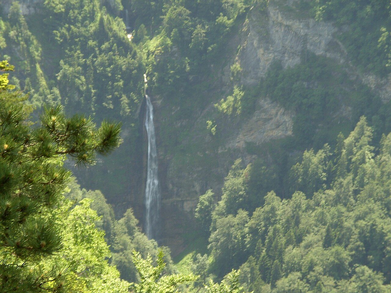 The tall Skakavac waterfall falling through the forest of Perućica in Sutjeska National Park