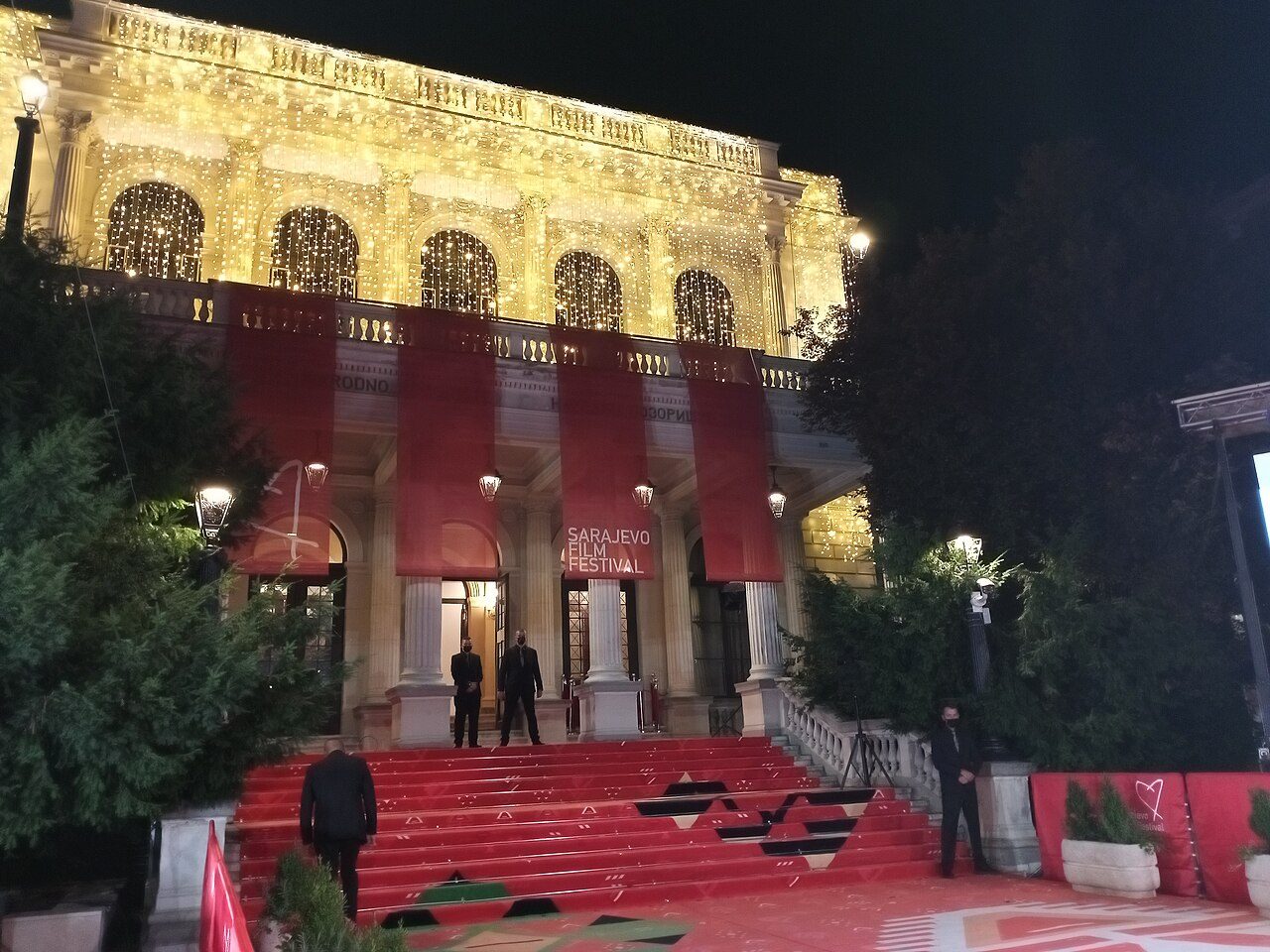 The National Theatre at night during the Sarajevo Film Festival, with a red carpet on the steps