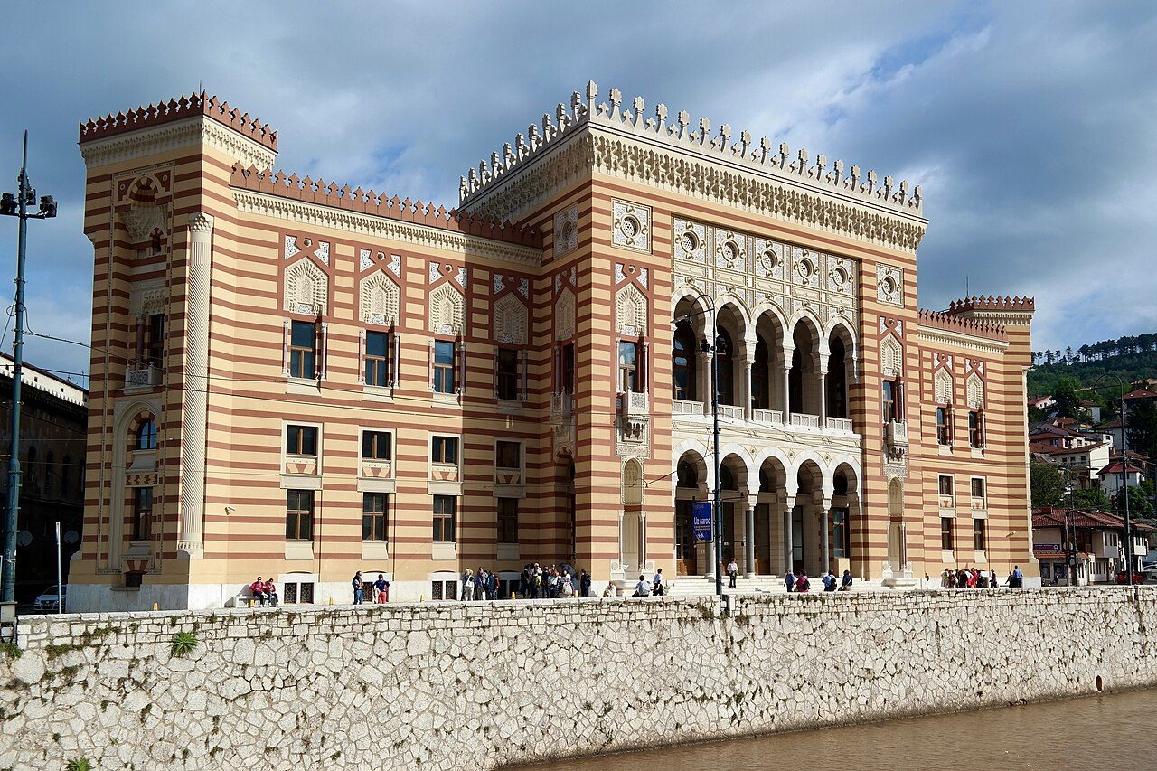 The striped Moorish facade of Vijećnica on the Miljacka riverbank
