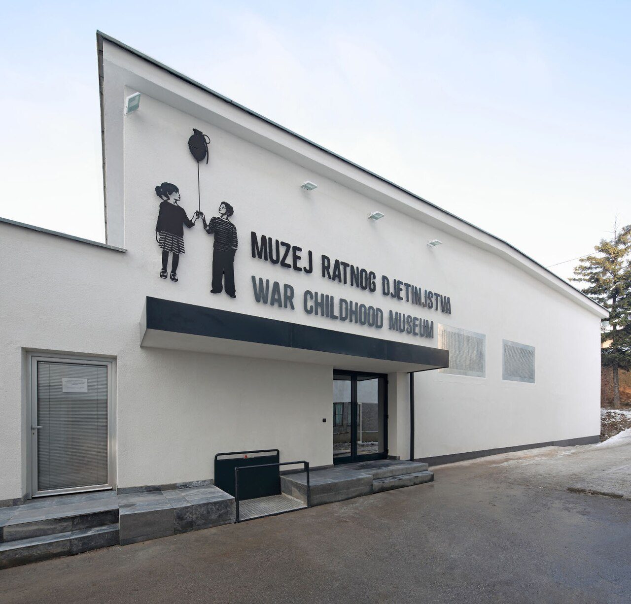 The white front of the War Childhood Museum with its sign and the figures of two children